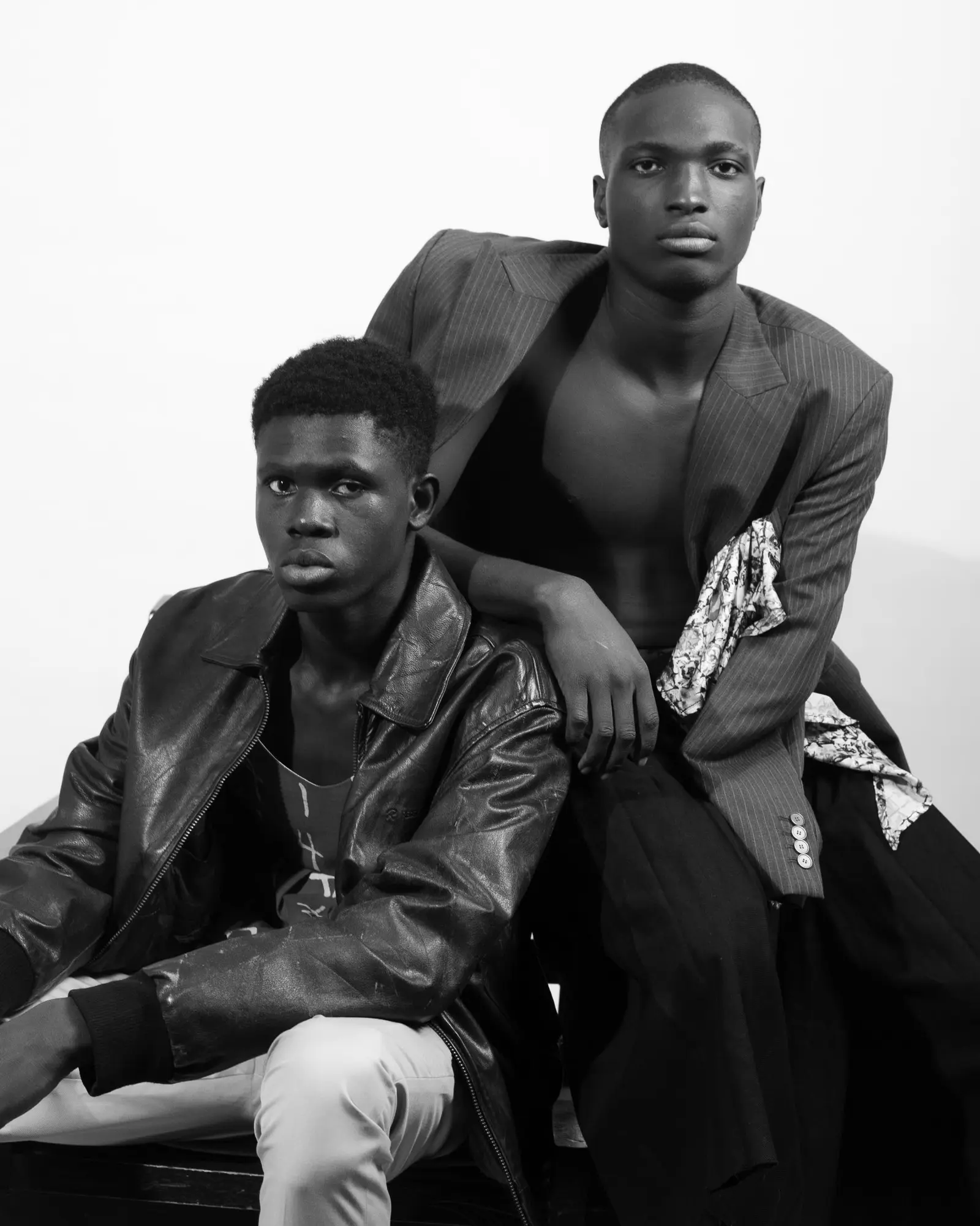 Potret hitam putih dua model dengan jaket kulit