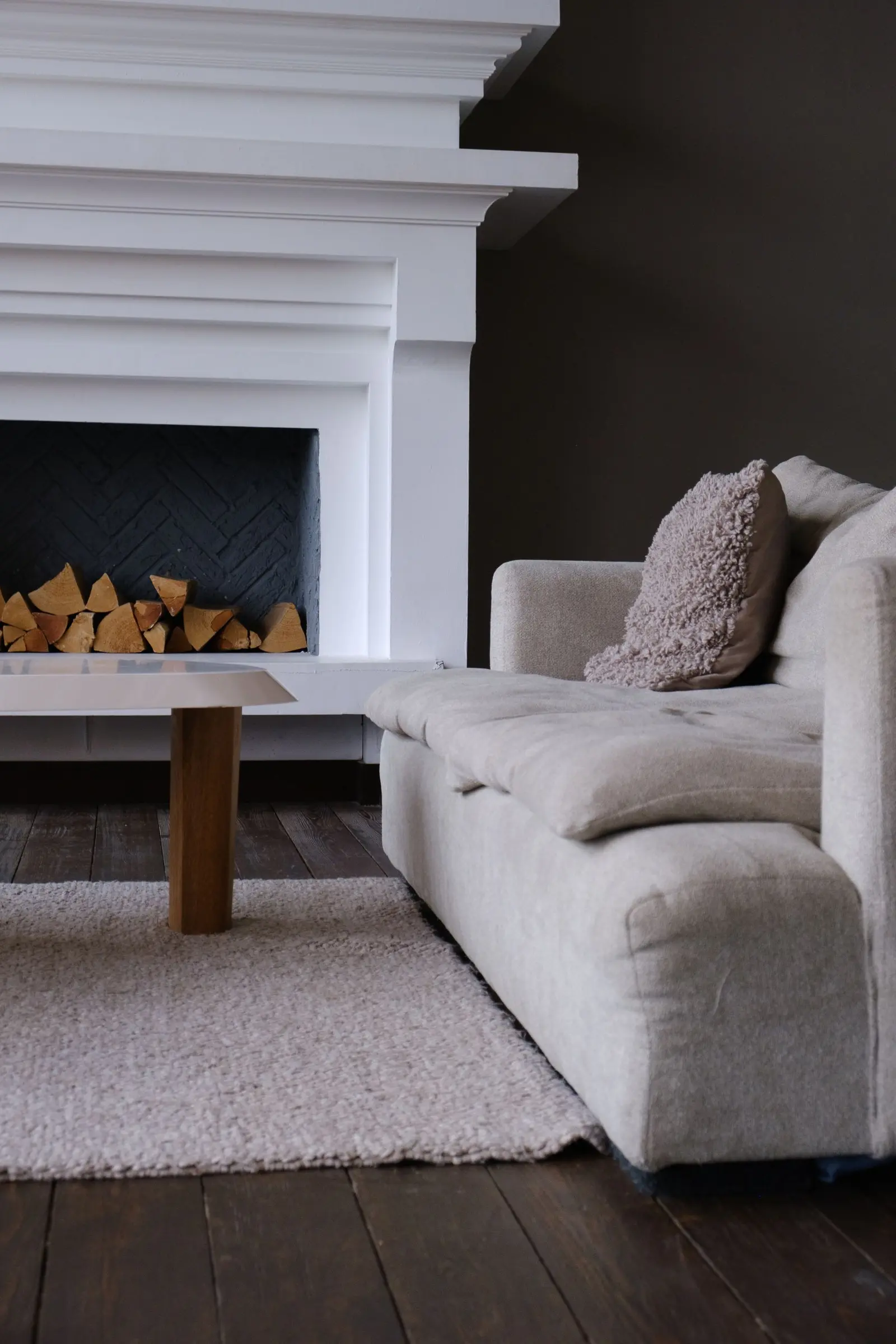 Sudut ruang dengan sofa putih dan bantal bertekstur